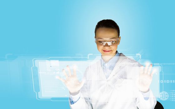 Image of young woman scientist touching icon of media screen