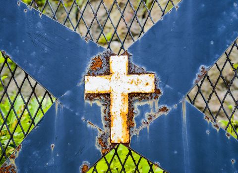 Rusty cross on steel