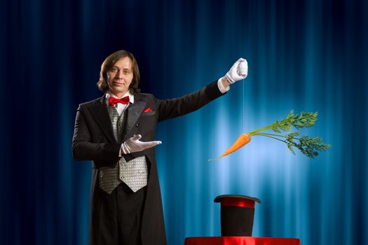 Image of magician taking carrot out of magic hat