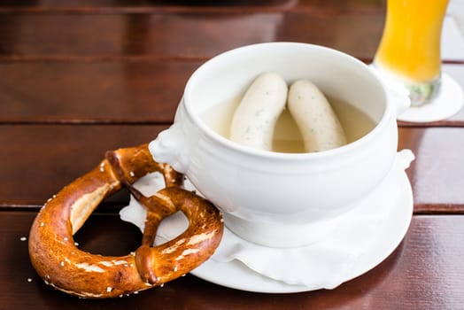 Weisswurst - typical Bavarian white sausages with Pretzel and Hefeweizen (wheat beer)