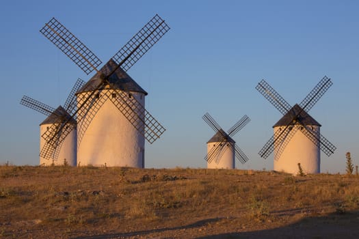 Late afternoon sunlight on the windmills of Campo de Criptana in the La Mancha region of central Spain.