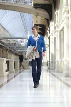 Young man walking in the store