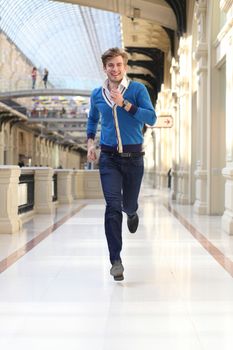 Young man running in the store