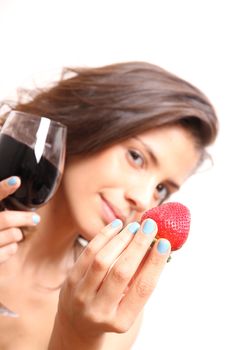 Portrait of a beautiful, latin Woman eating a Strawberry and drinking wine.