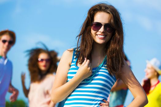 Image of young attractive woman with friends at background