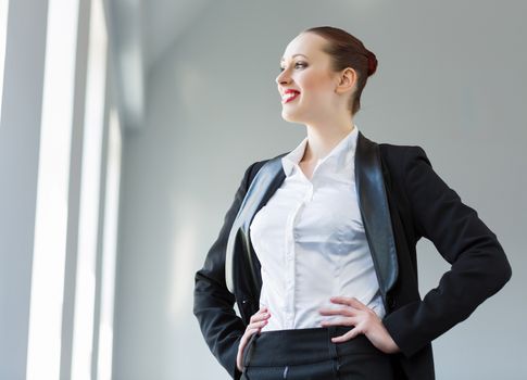 Image of young attractive businesswoman in business suit smiling