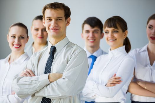 Young business people standing with arms crossed on chest