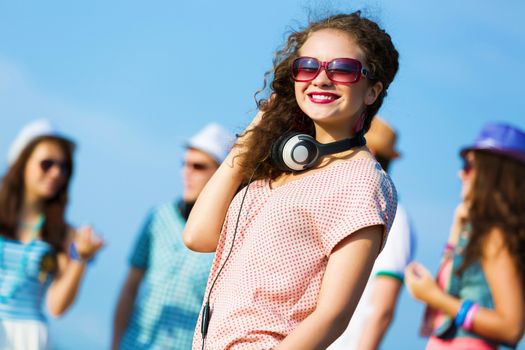 Image of young attractive woman with friends at background