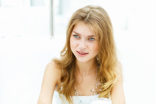 Portrait of a young blond woman sitting in cafe