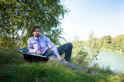 business man using laptop in the field