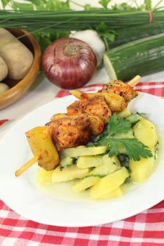 a Potato-cucumber salad with a fiery skewer