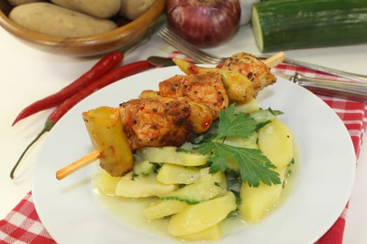 a Potato-cucumber salad with a fiery skewer