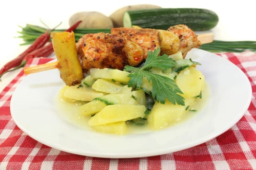 a Potato-cucumber salad with a fiery skewer