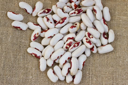 bunch of white beans on sacking