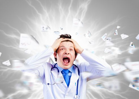 Image of young male doctor screaming in madness