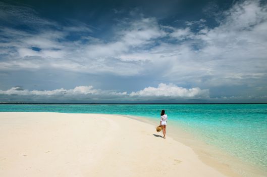 Woman in sun hat at tropical beach