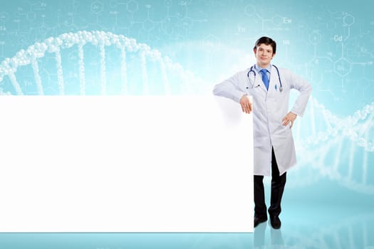 Young male doctor with blank banner. Place for text