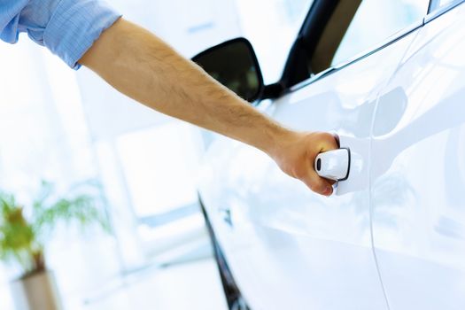 Close up human hand opening car door