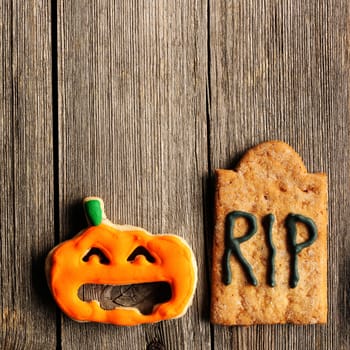 Halloween homemade gingerbread cookies over wooden table