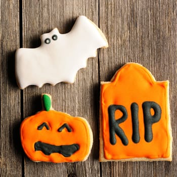 Halloween homemade gingerbread cookies over wooden table