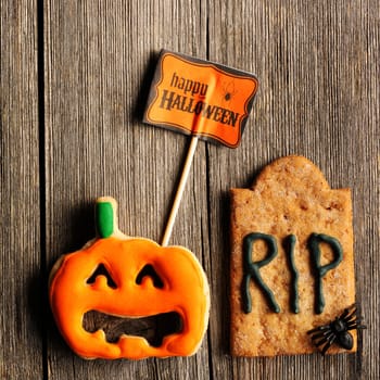 Halloween homemade gingerbread cookies over wooden table