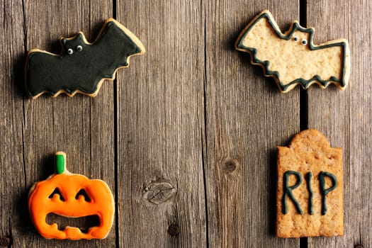 Halloween homemade gingerbread cookies over wooden table