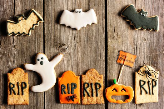 Halloween homemade gingerbread cookies over wooden table