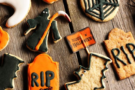 Halloween homemade gingerbread cookies over wooden table