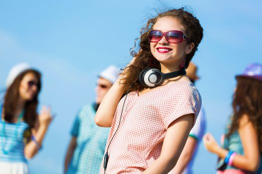 Image of young attractive woman with friends at background