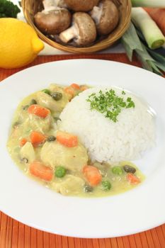 Chicken fricassee with rice, vegetables, capers and parsley