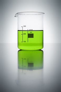 A glass with green liquid in a laboratory