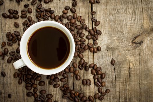 A Coffee Cup with beans on wooden background