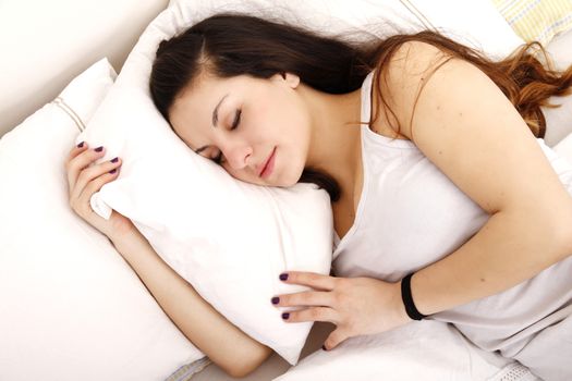 A young adult Woman sleeping on the Bed.