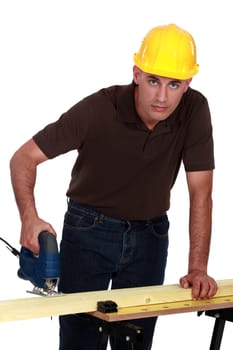 craftsman making holes in a board with a drill