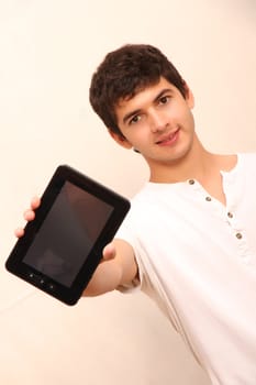 A young, latin man with a Tablet PC, face in focus
