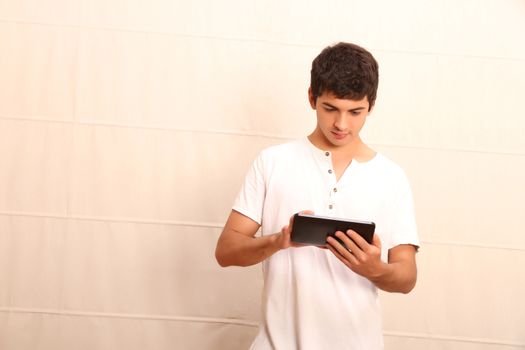 A young, latin man with a Tablet PC, face in focus
