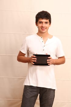 A young, latin man with a Tablet PC, face in focus
