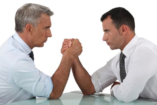 businessmen arm wrestling