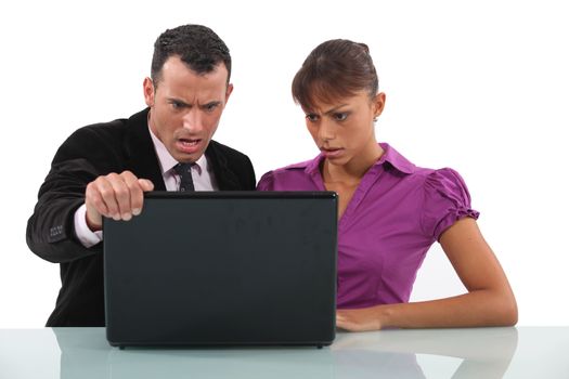businessman and secretary getting angry over laptop