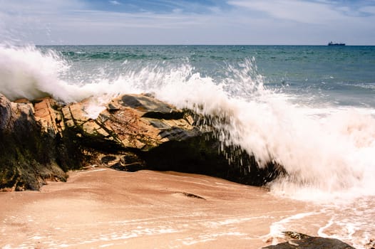 Splash against rocks at the shore of Porto Covo Beach on Alentejo, Portugal