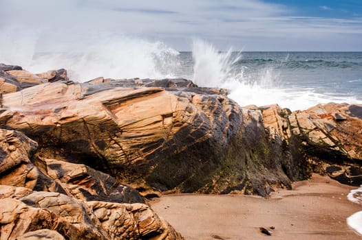 Splash against rocks at the shore of Porto Covo Beach on Alentejo, Portugal