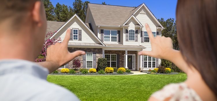 House and Military Couple Framing Hands in Front Yard.