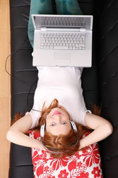 A young woman surfing on the Internet with a Laptop.  