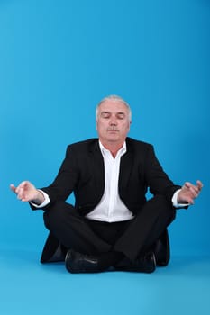 Businessman sitting in a lotus position