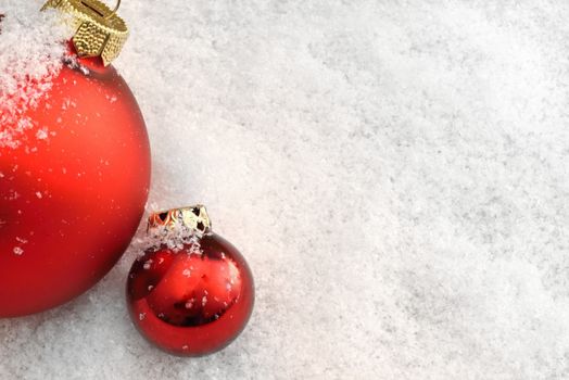 Red Christmas balls in the snow