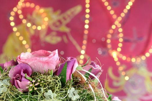 Pink background with lights and a flower