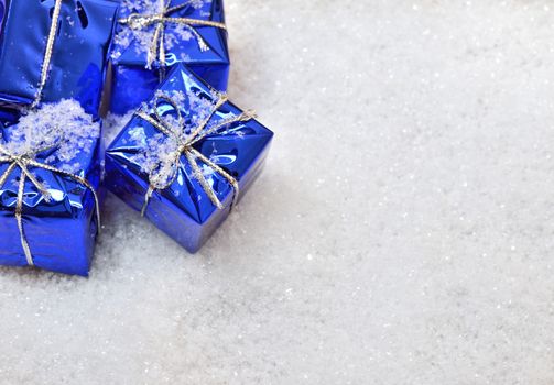 Blue Christmas gifts in the snow