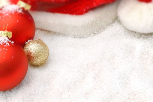 Balls and Santa hat in the snow