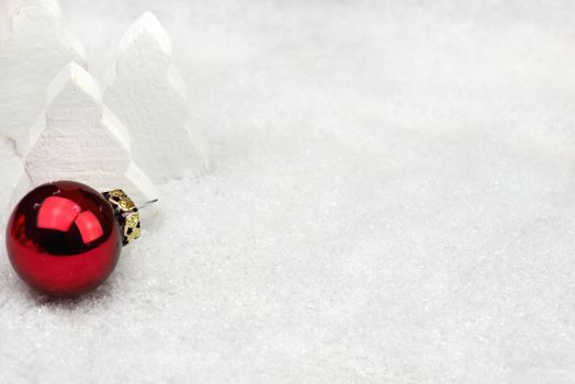 Red Christmas ball in the snow