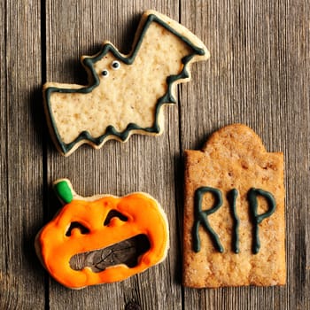 Halloween homemade gingerbread cookies over wooden table